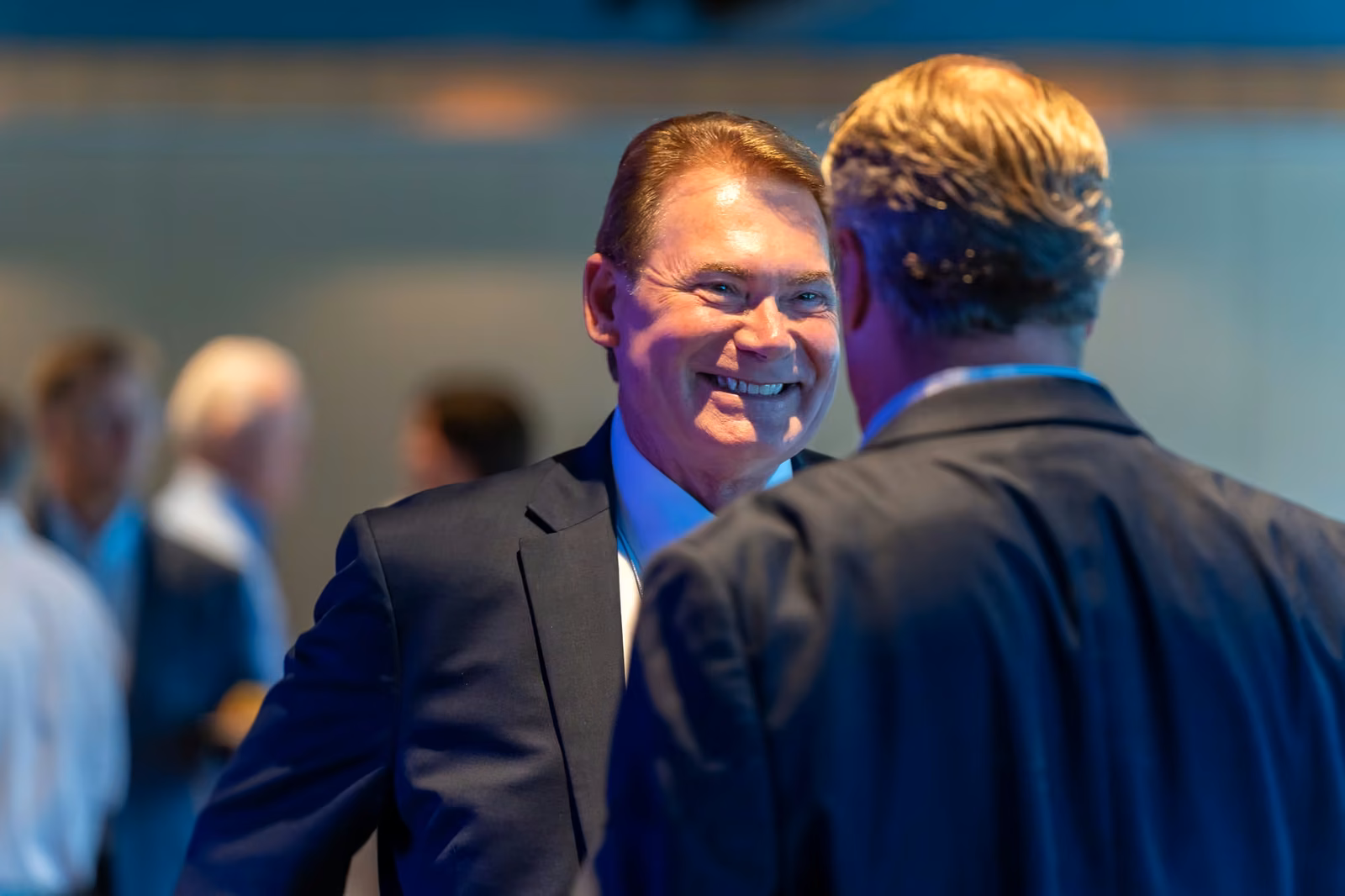 Two delegates talking at a conference reception