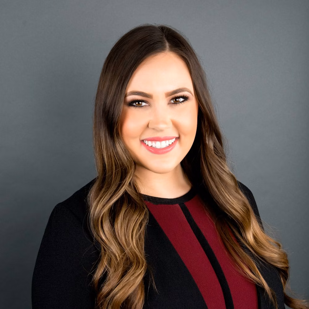 Consistent corporate headshot on studio backdrop